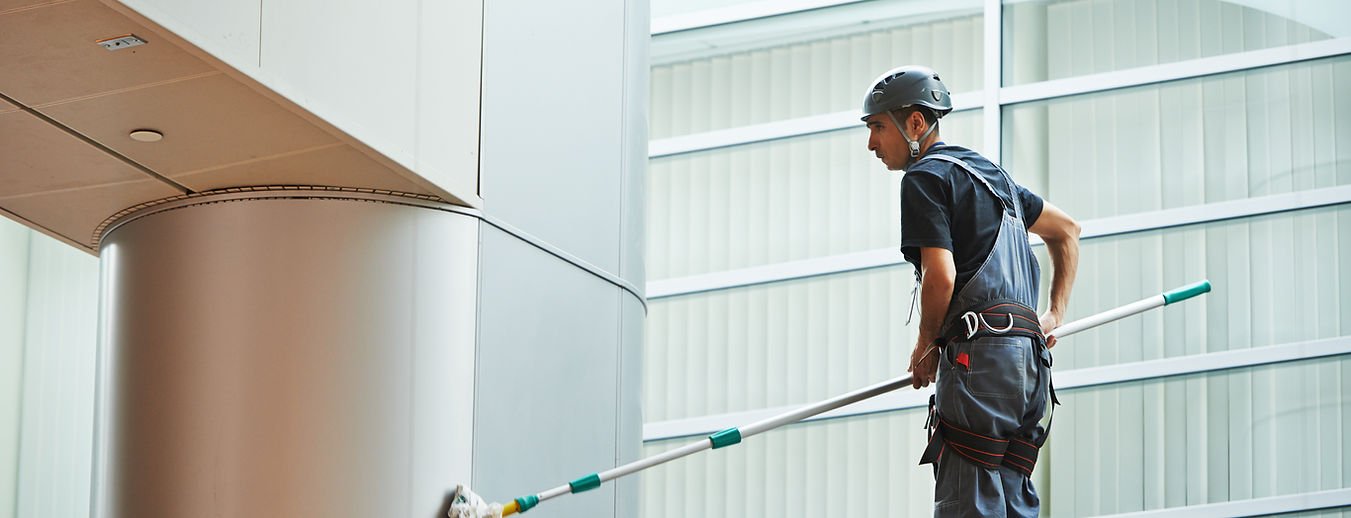 FM operative cleaning in a large modern building atrium — representing healthcare and institutional FM delivery